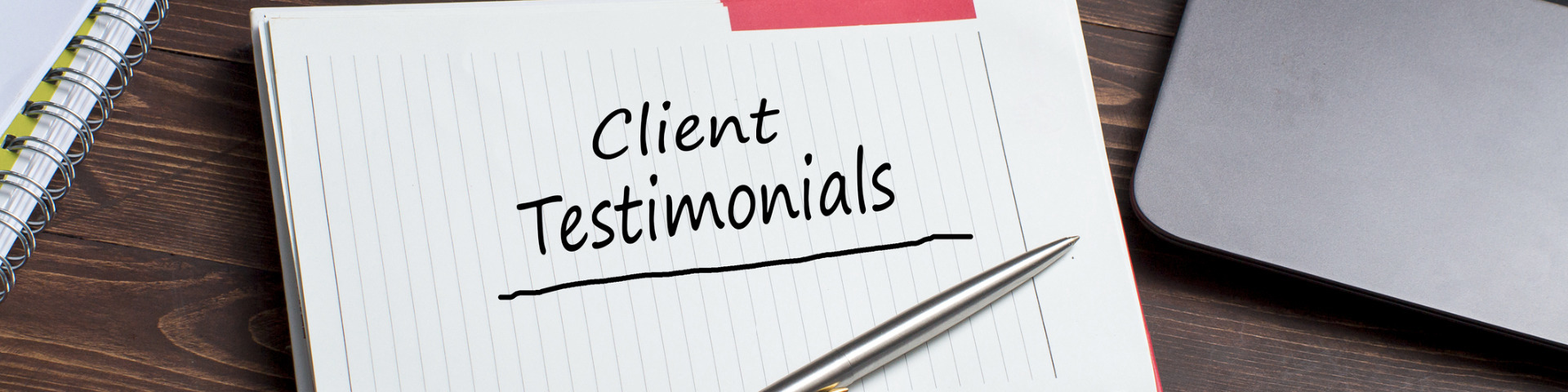 Note pad with clients testimonials written across the page