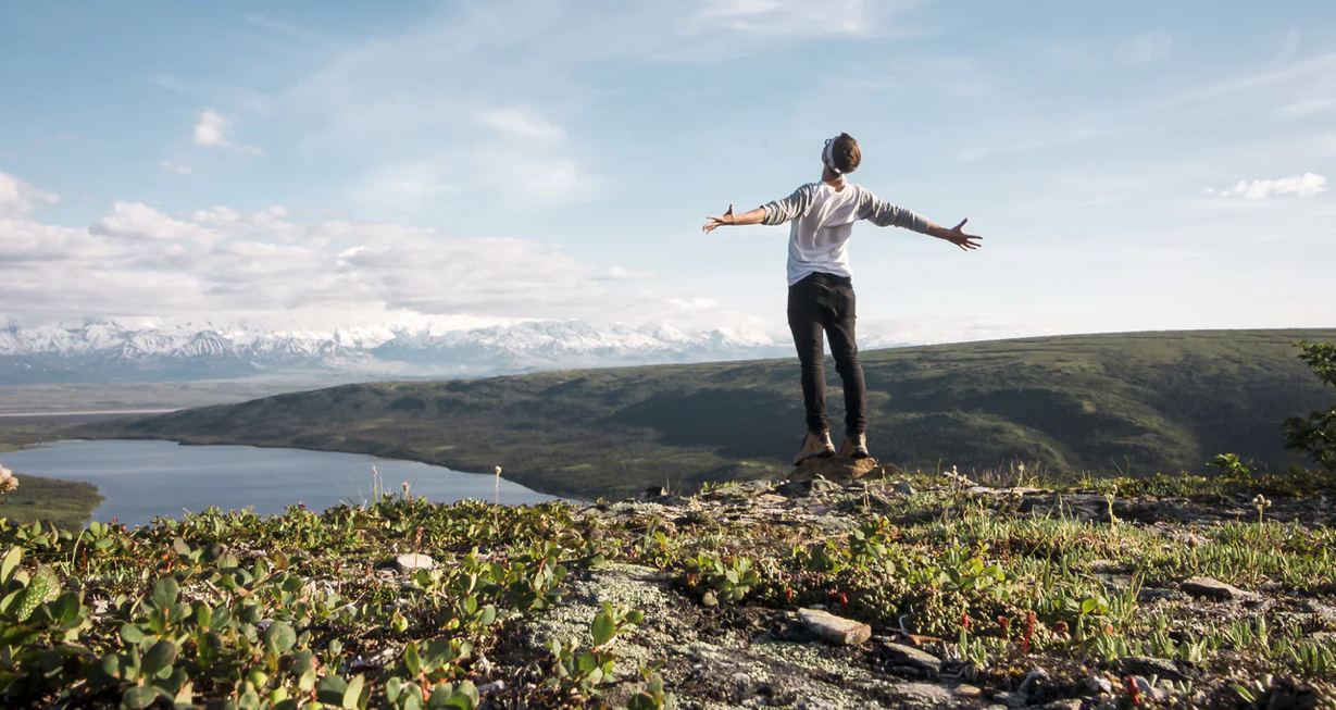 Hair loss and the mental effects - man standing on a mountain top overlooking a lake